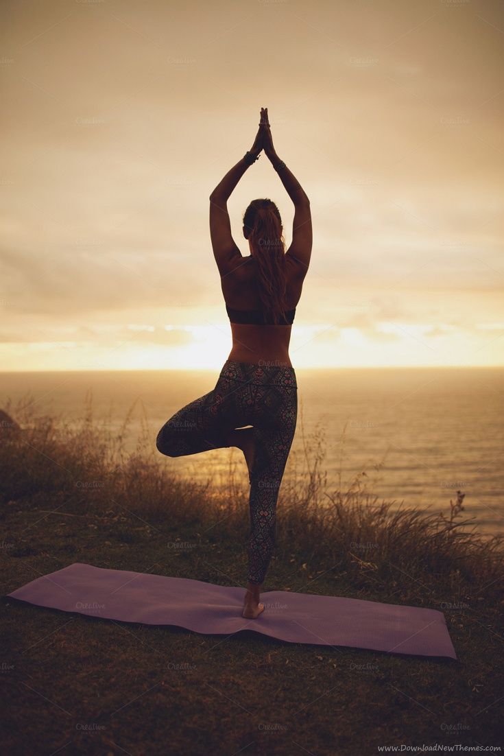 Female doing tree pose yoga